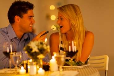young couple having romantic dinner together in a restaurant